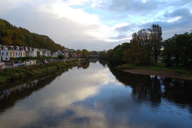 View from the bridge over the River Lee at Western Road and the Mardyke Arena: reflections in the river and a cloudy sky overhead.