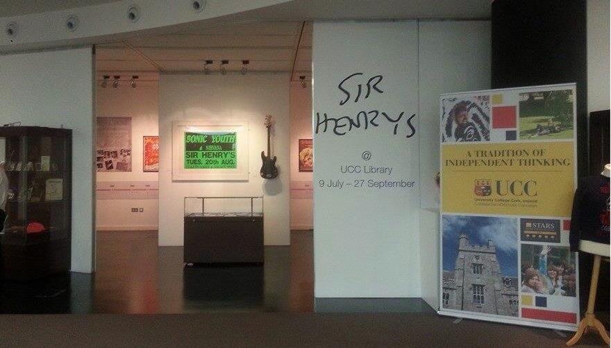 View of the storyboards and entrance to the exhibition with a Sonic Youth poster and a guitar.