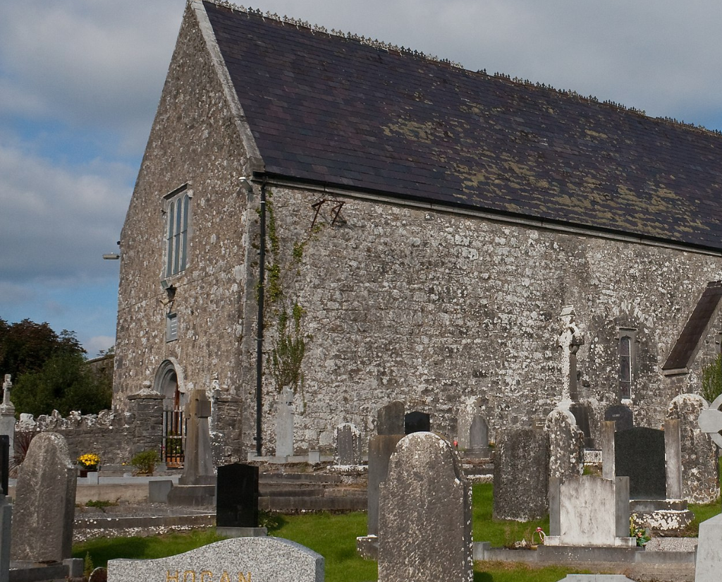 The outside of Meelick friary with gravestones in the foreground.