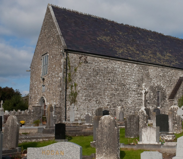 The outside of Meelick friary with gravestones in the foreground.