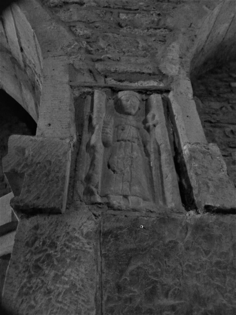 Stone statue of Saint Francis on the wall of Meelick Franciscan friary, interior.