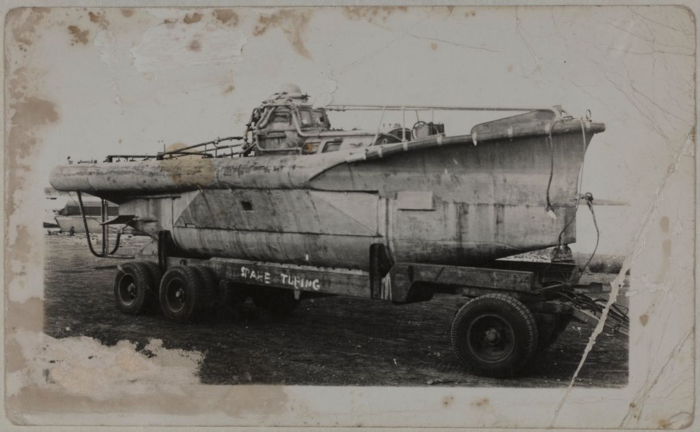 Image of a British Welfreighter midget submarine being transported on land on a trailer
