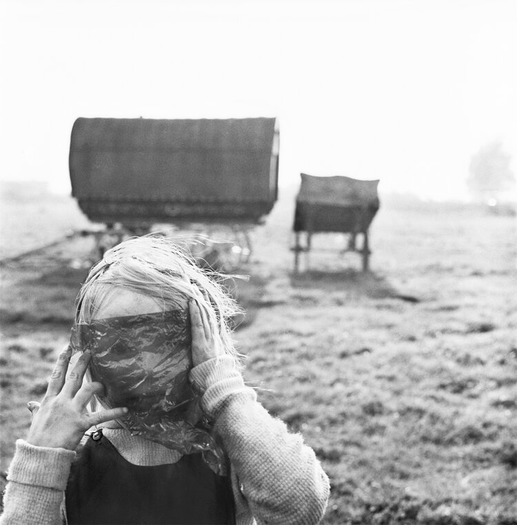 Black and white photo by Alen MacWeeney of child with cellophane over face.