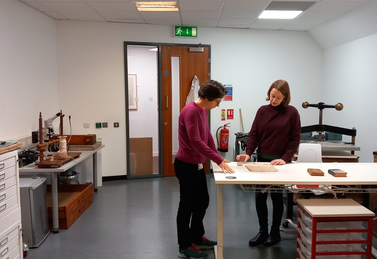 conservator and archivist discuss treatment of damaged items