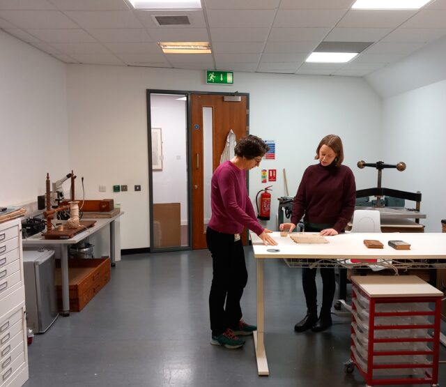 conservator and archivist discuss treatment of damaged items